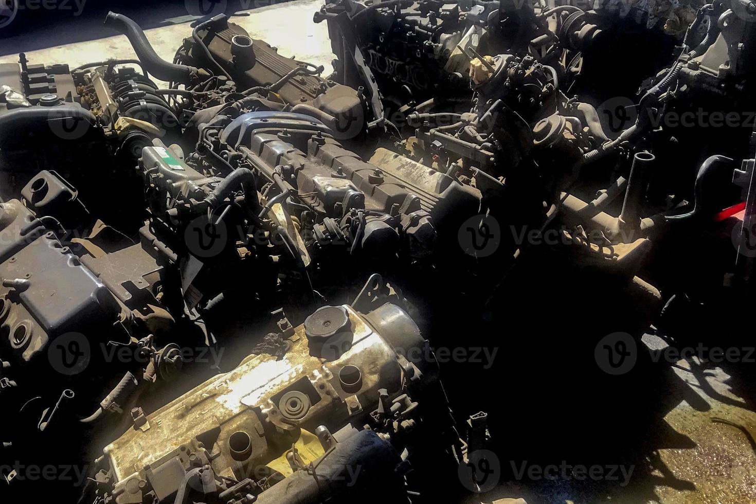 many old used car engine and parts photo
