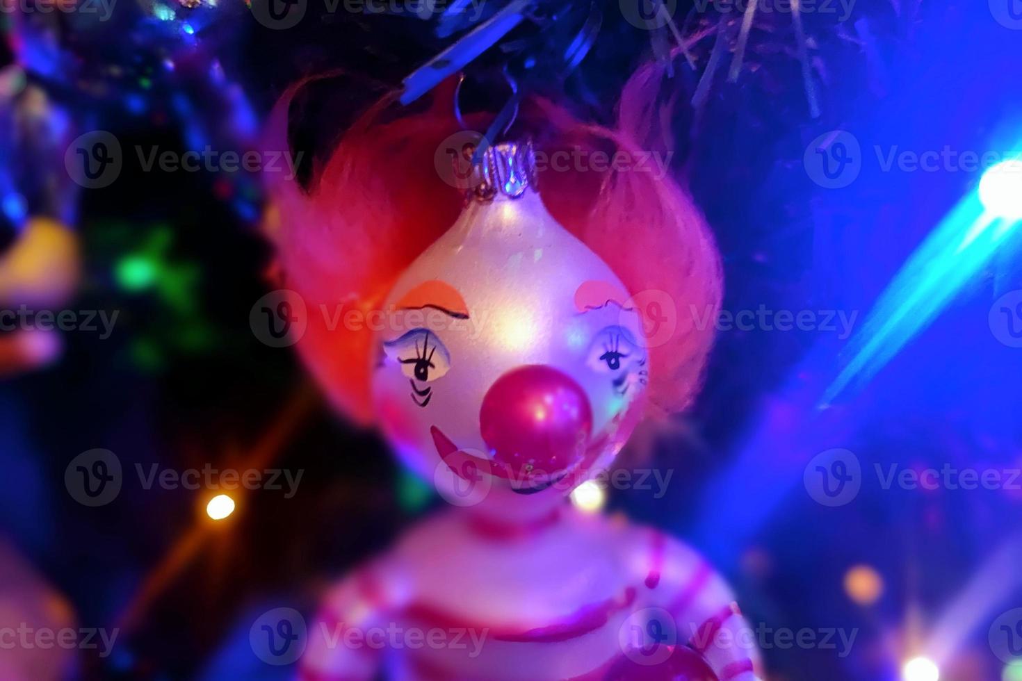 Circus clown glass hand made christmas ball on xmas tree detail blur lights photo