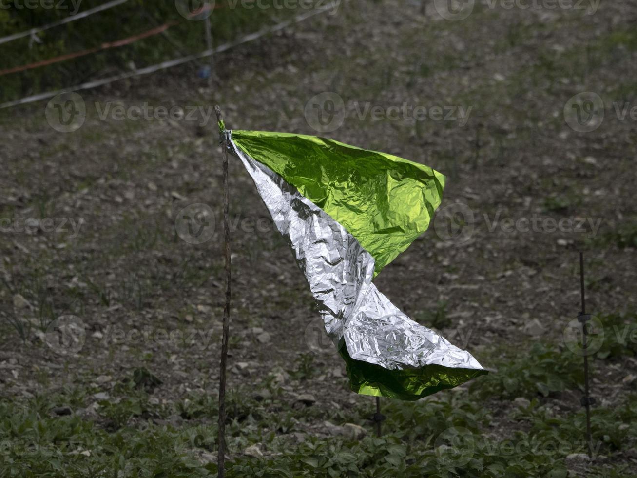 metal sheet scarecrow in a field photo