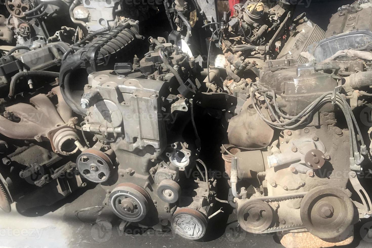 many old used car engine and parts photo