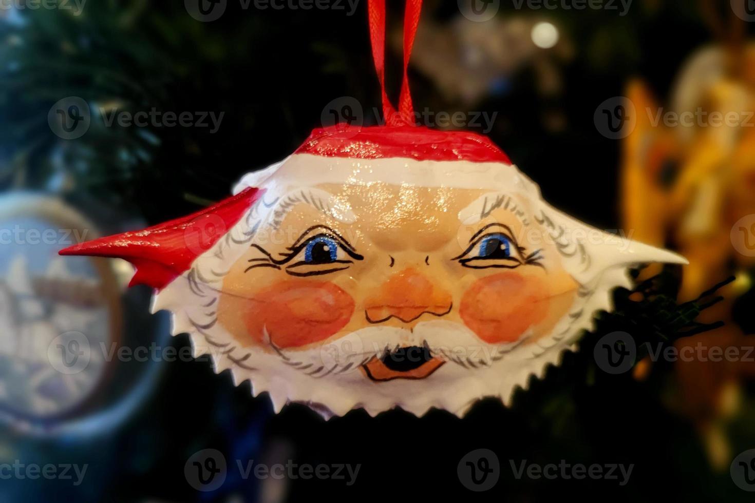 Santa crab hand made christmas ball on xmas tree detail blur lights photo