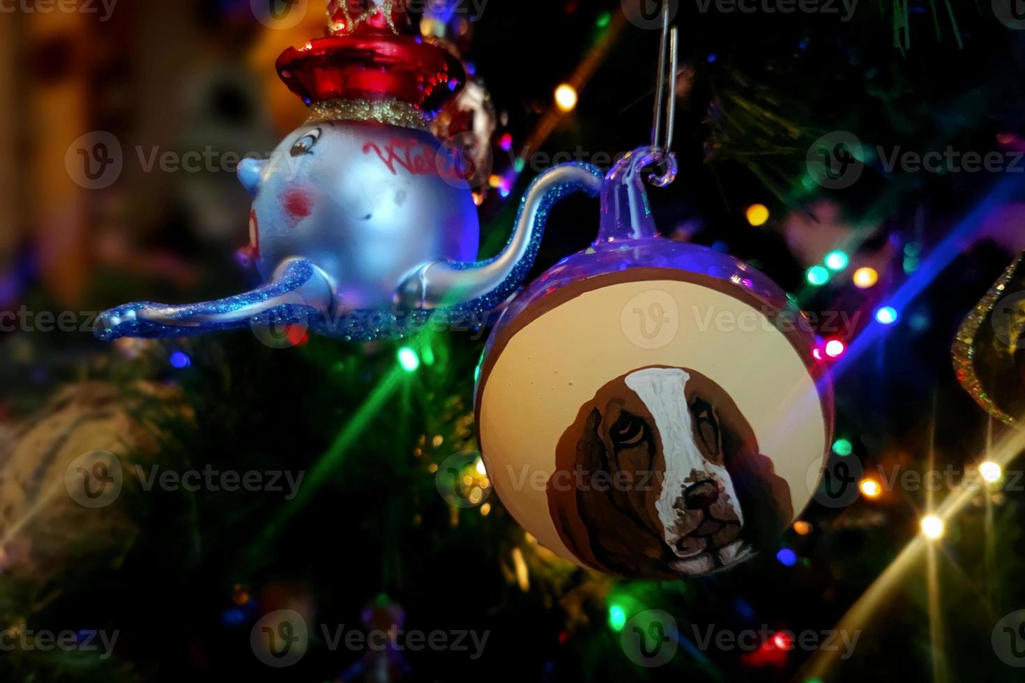 Dog glass hand made christmas ball on xmas tree detail blur lights photo