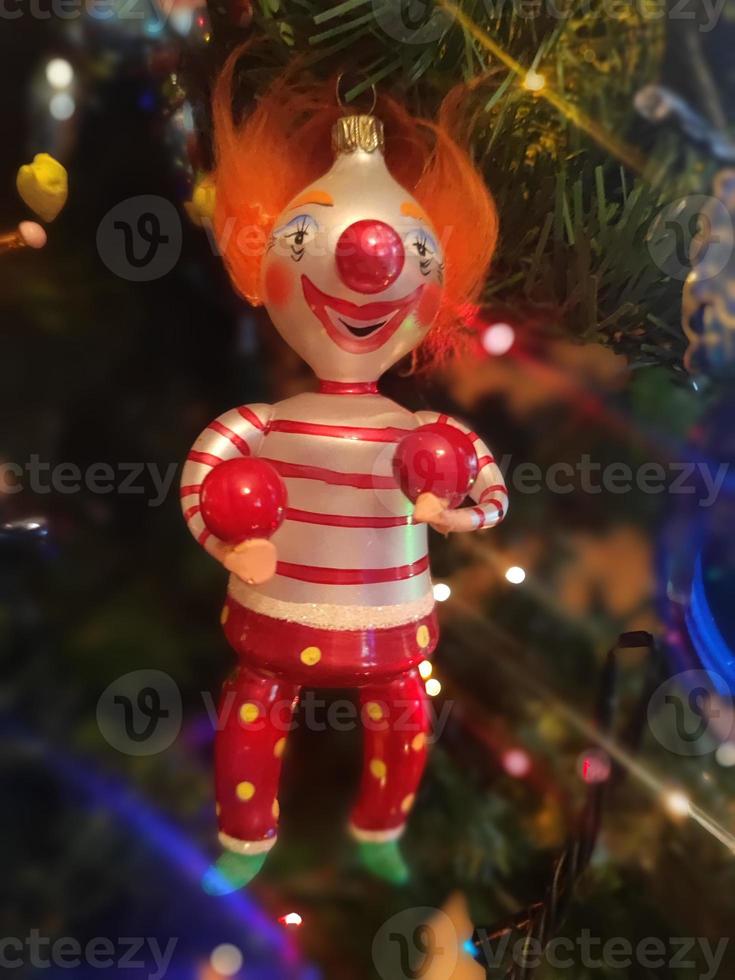 Circus clown glass hand made christmas ball on xmas tree detail blur lights photo