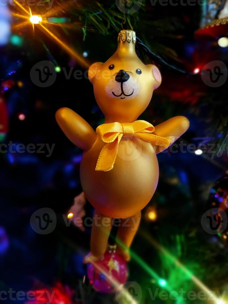 Circus Bear glass hand made christmas ball on xmas tree detail blur lights photo