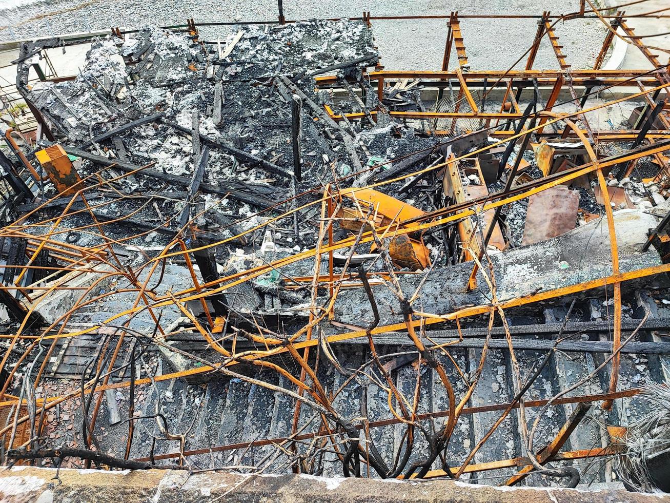 burned metal structure after fire by the sea photo