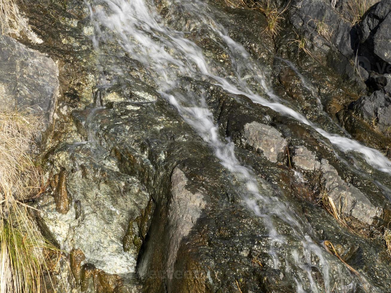 Creek water on rock photo