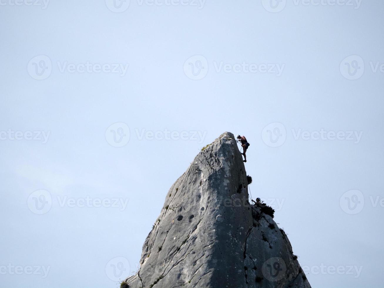 climber on Goloritze rock cliff by the sea Sardinia Italy photo