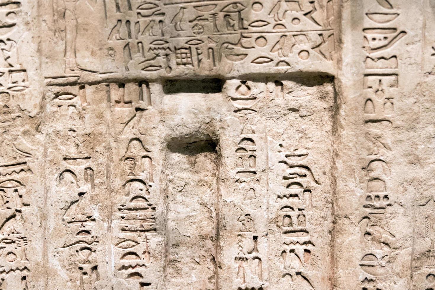 ancient hieroglyphs on stone detail photo