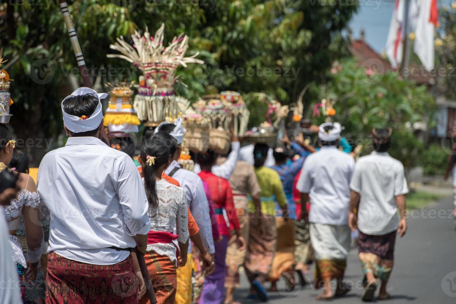 BALI, INDONESIA - AUGUST 17, 2016 - Balinese monk and worshipper at the temple for full moon celebration photo