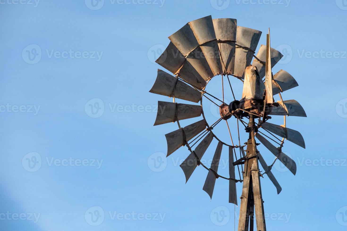 farm old windmill  for water on blue sky photo