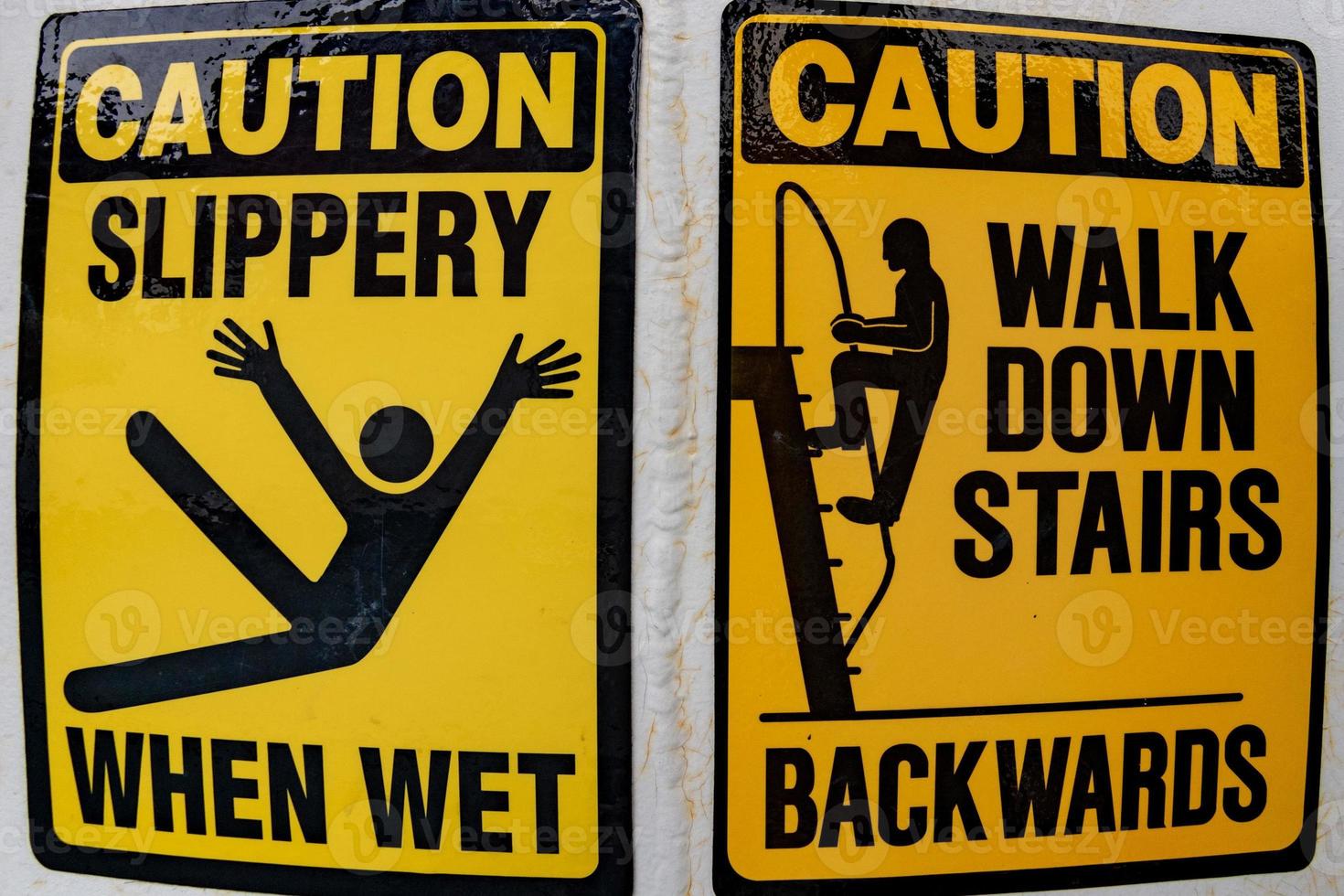 caution slippery when wet sign walk down stairs backwards photo