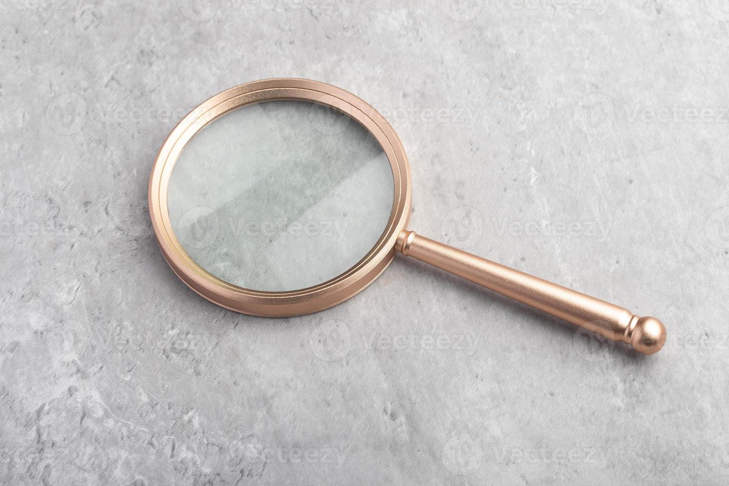 A magnifying glass on a gray background. For inserting images or text. photo