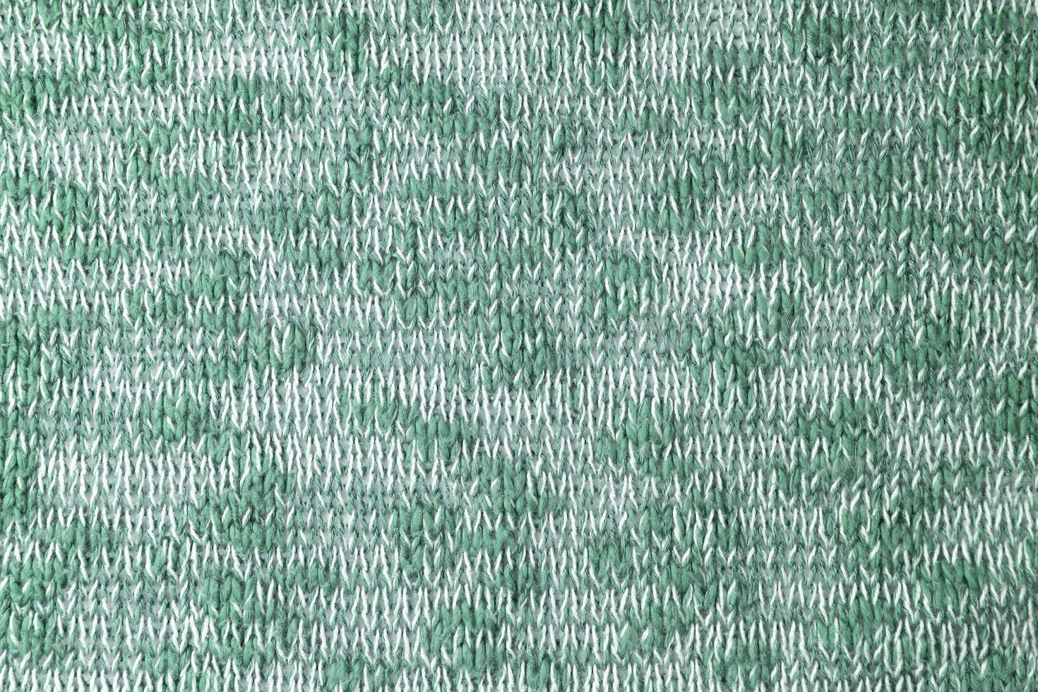 Bright green white melange knitwear wool fabric texture background. Abstract textile backdrop photo