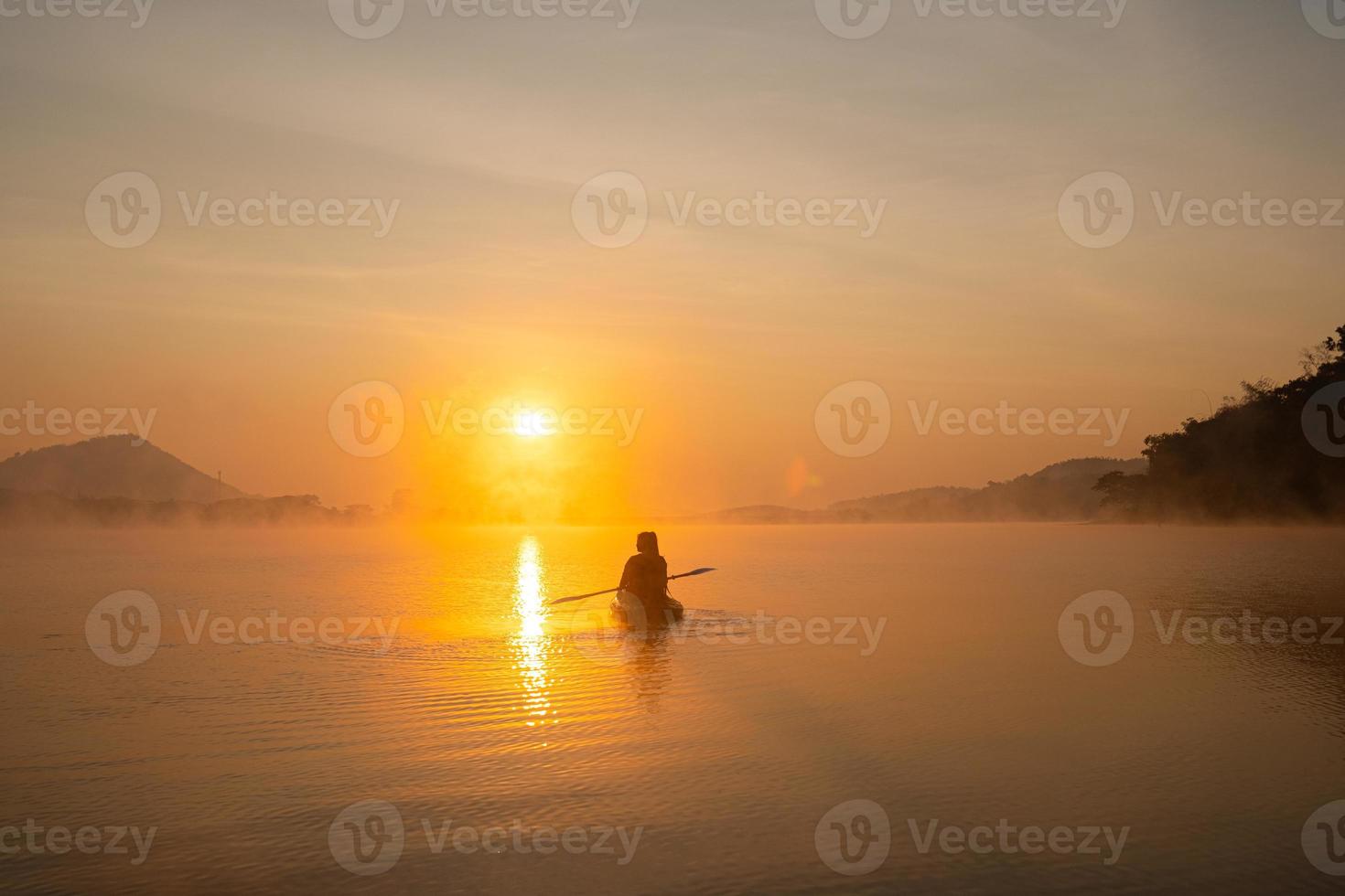 Women on kayak rows in the reservoir during the sunrise, Harirak forest park Huai Nam Man reservoir Loei Thailand 21 Jan 2023 photo
