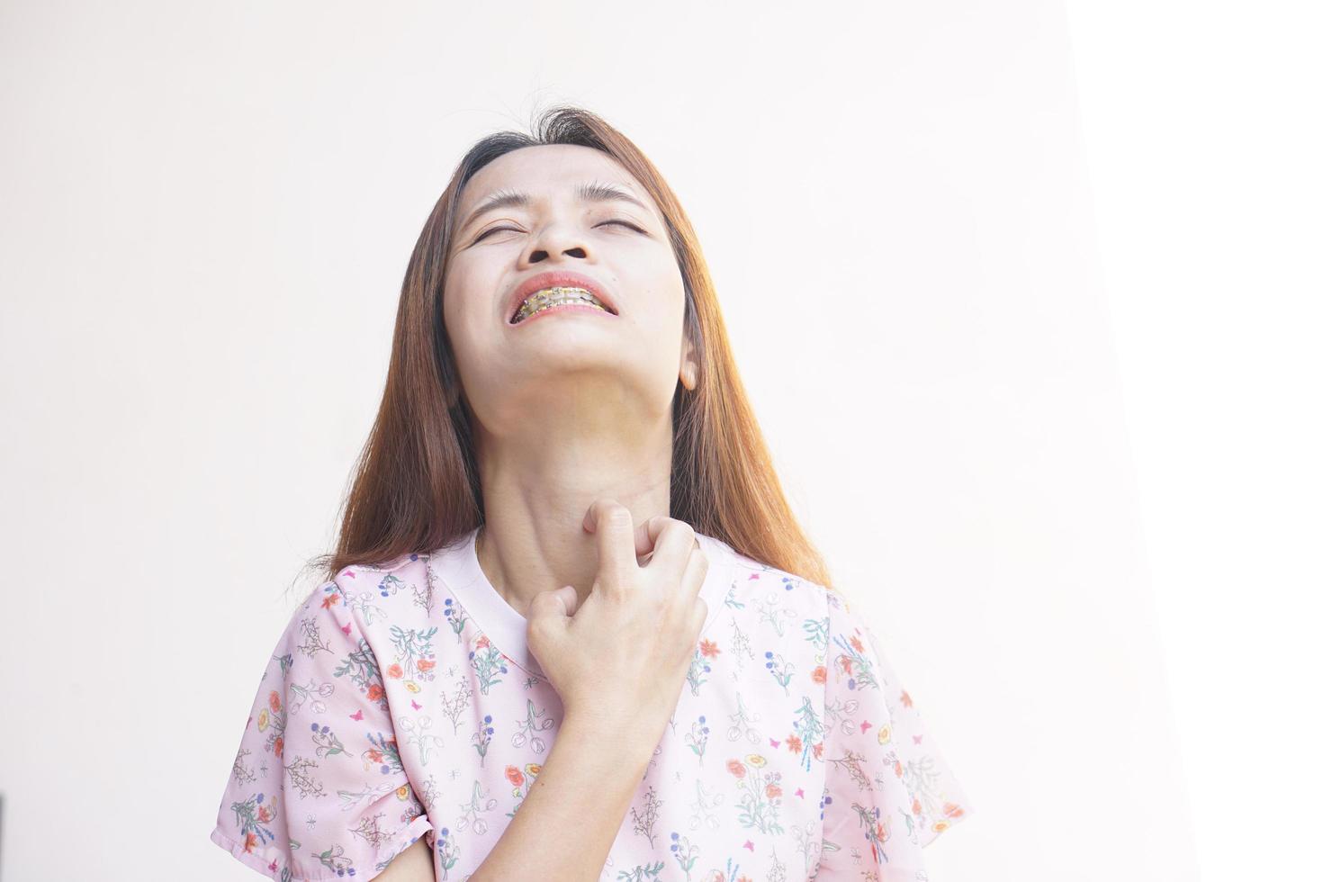 Asian woman having an itchy neck photo