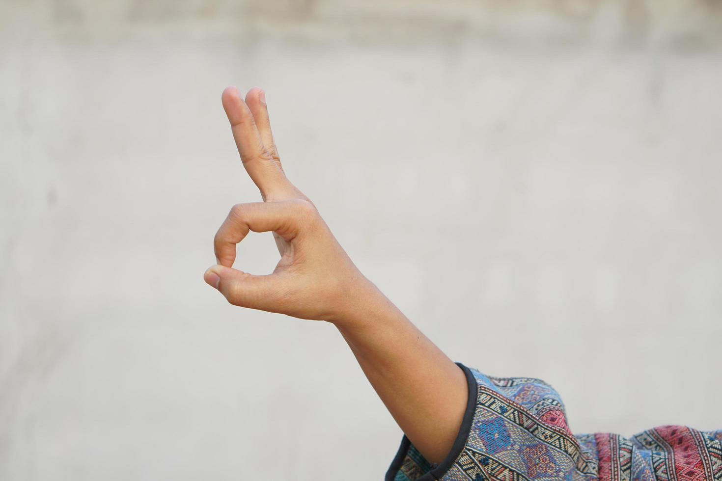Woman doing hand gestures as a sign of ok photo