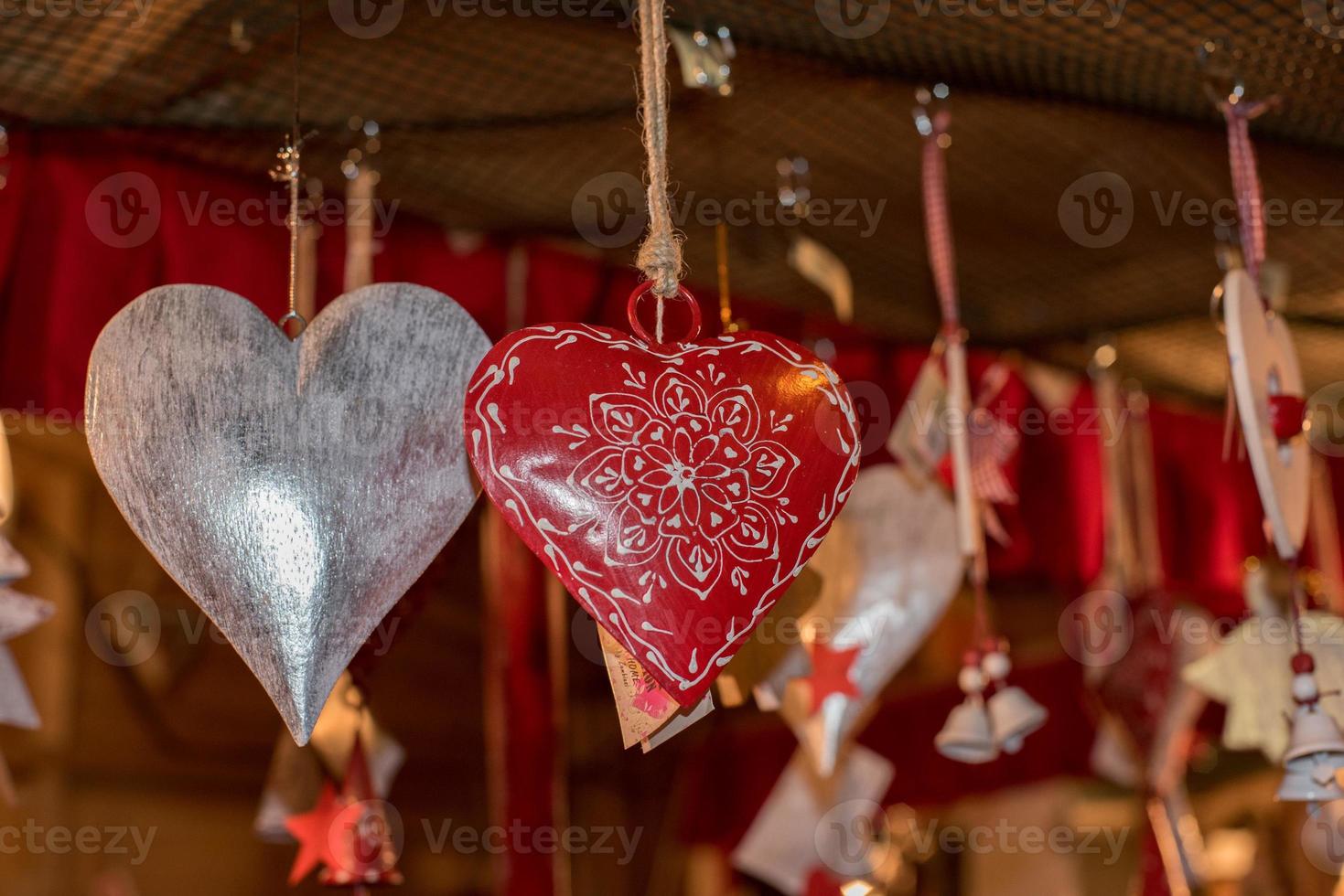 red heart christmas decorations at street market photo