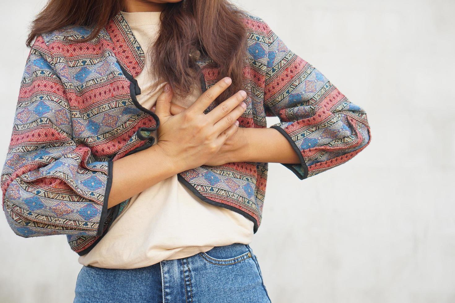 Asian woman having chest tightness, shortness of breath photo