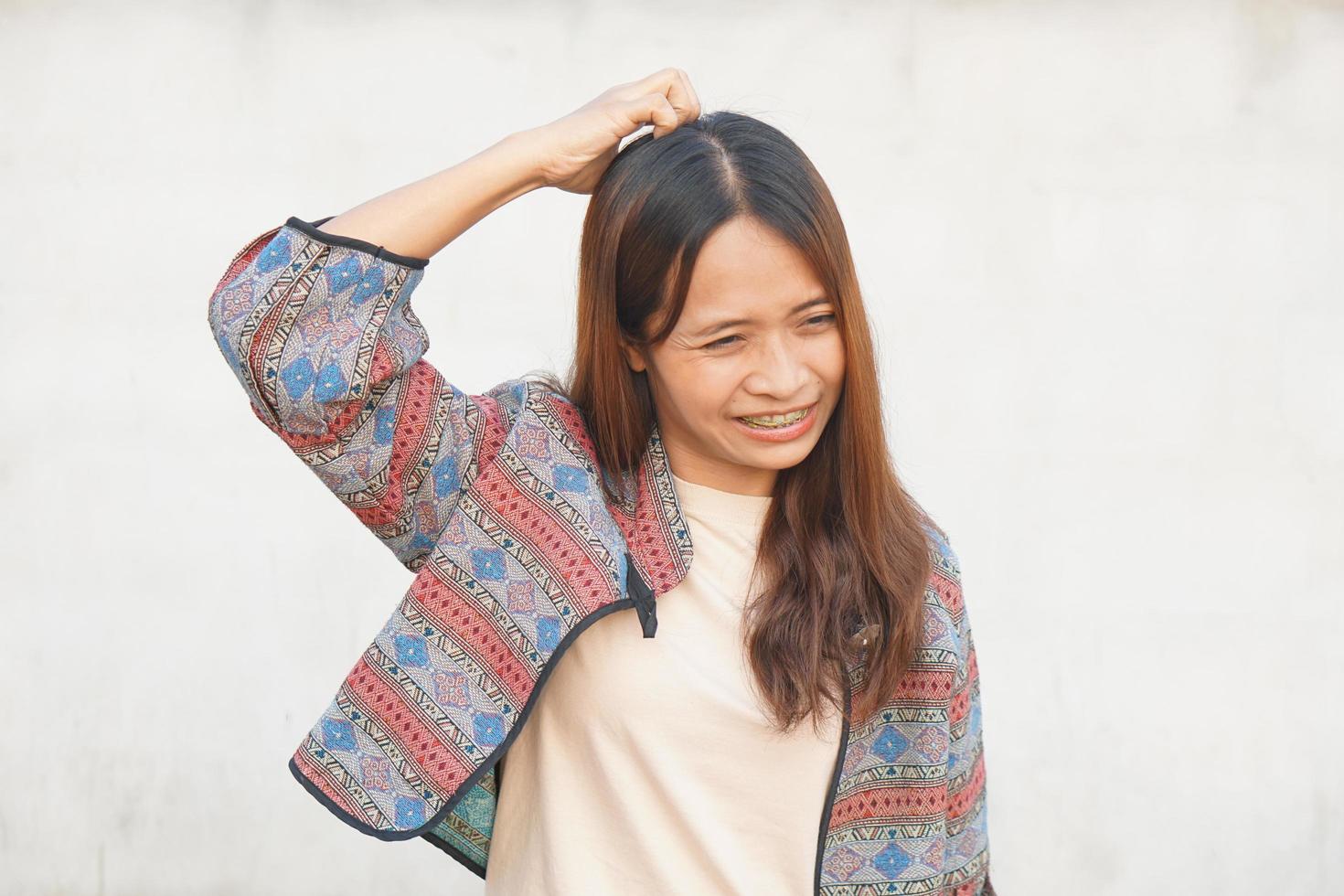 Asian woman has itchy head from dandruff photo