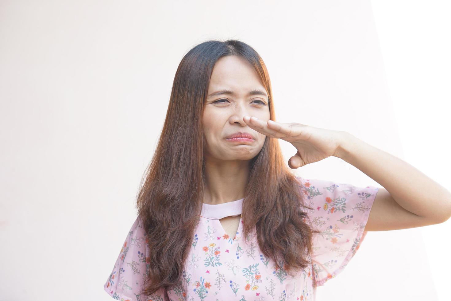 Asian woman smells bad from the blowing wind photo