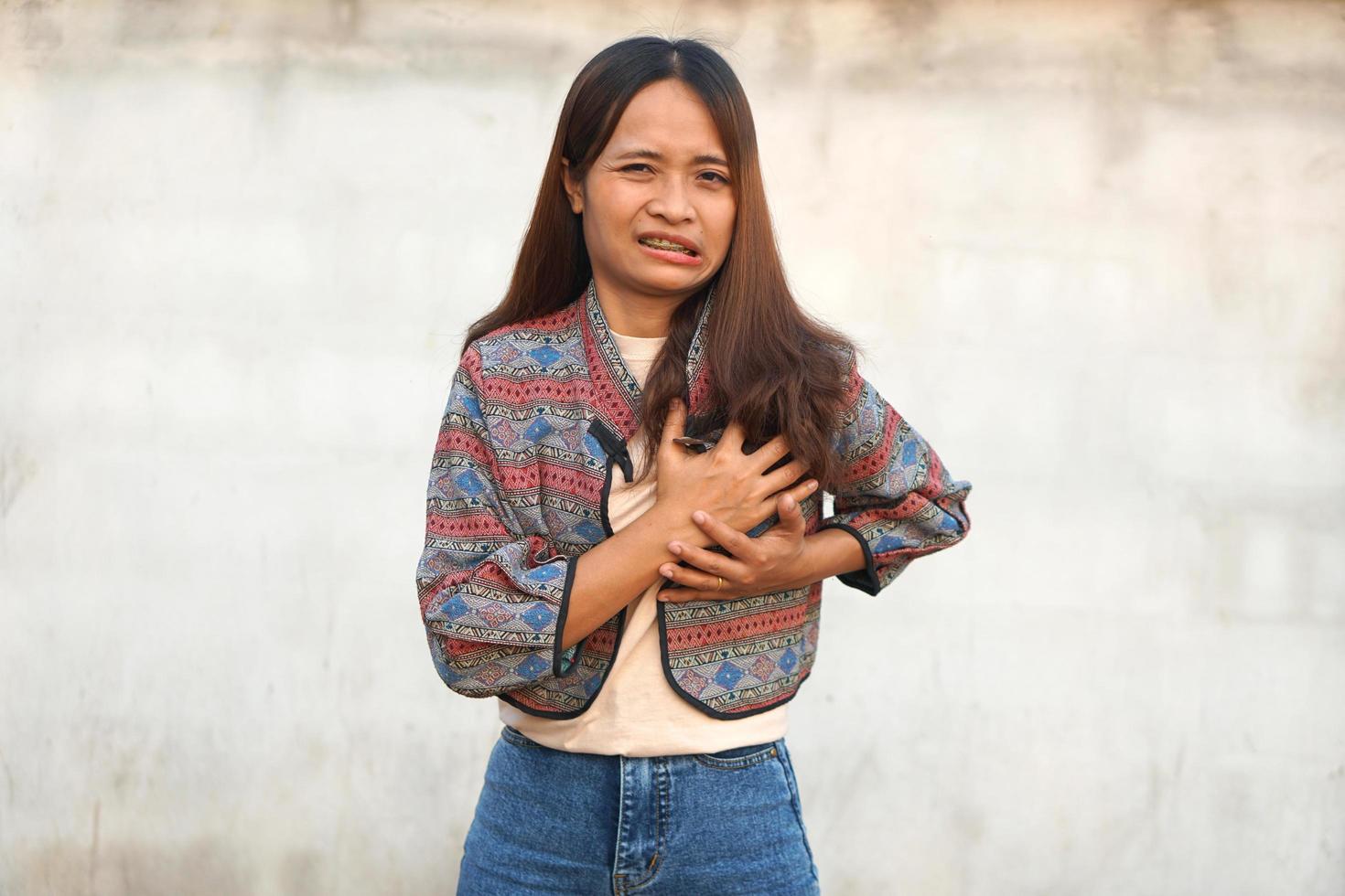 Asian woman having chest tightness, shortness of breath photo