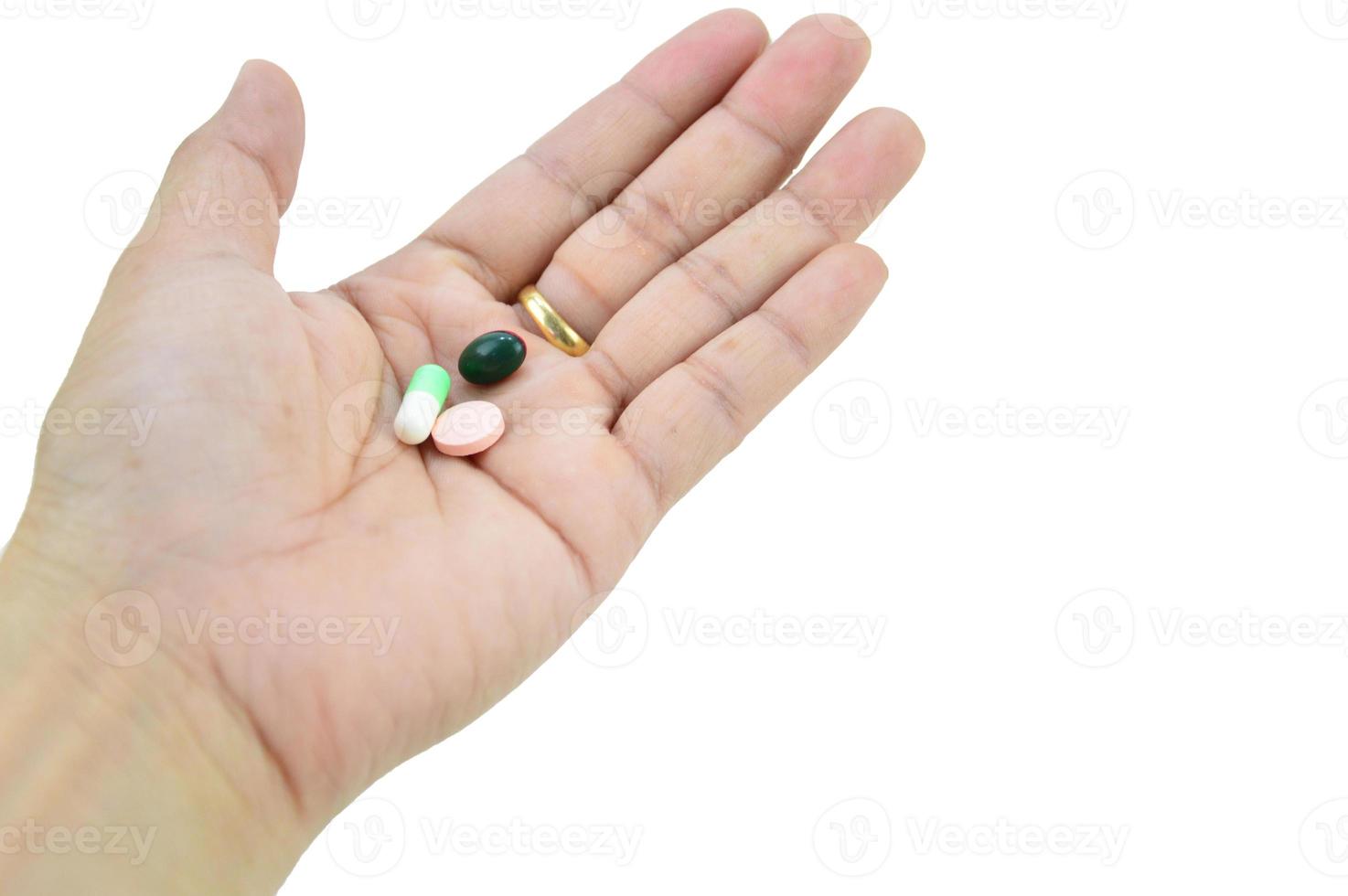 A hand with a pill on it, with clipping path photo