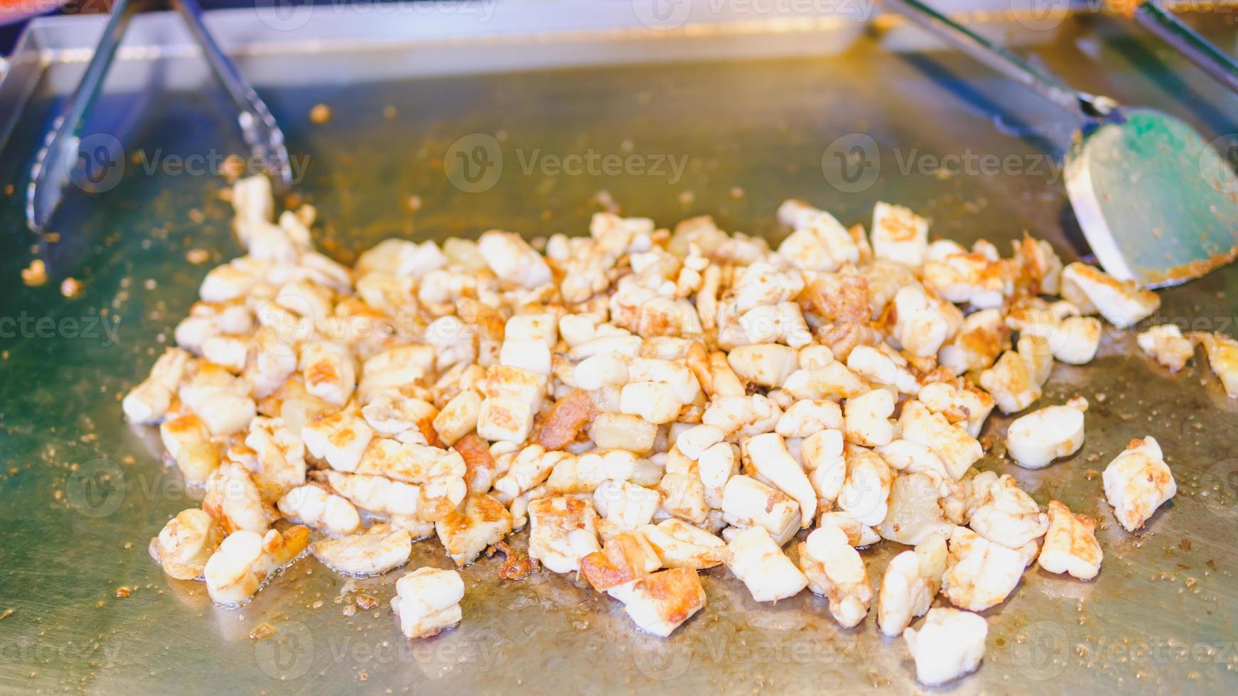 Deep-fried squid eggs are being fried in a pan. photo