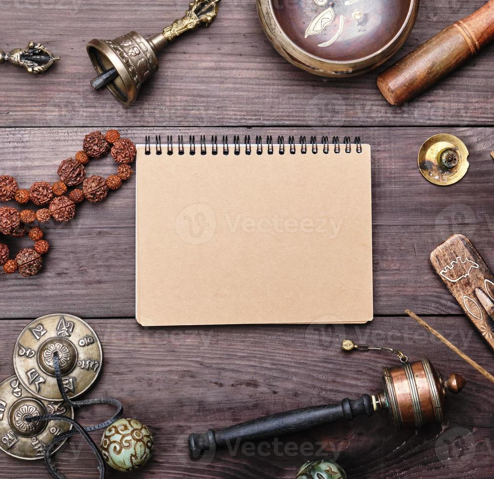 religious musical instruments for meditation and alternative medicine, blank notebook with brown sheets photo