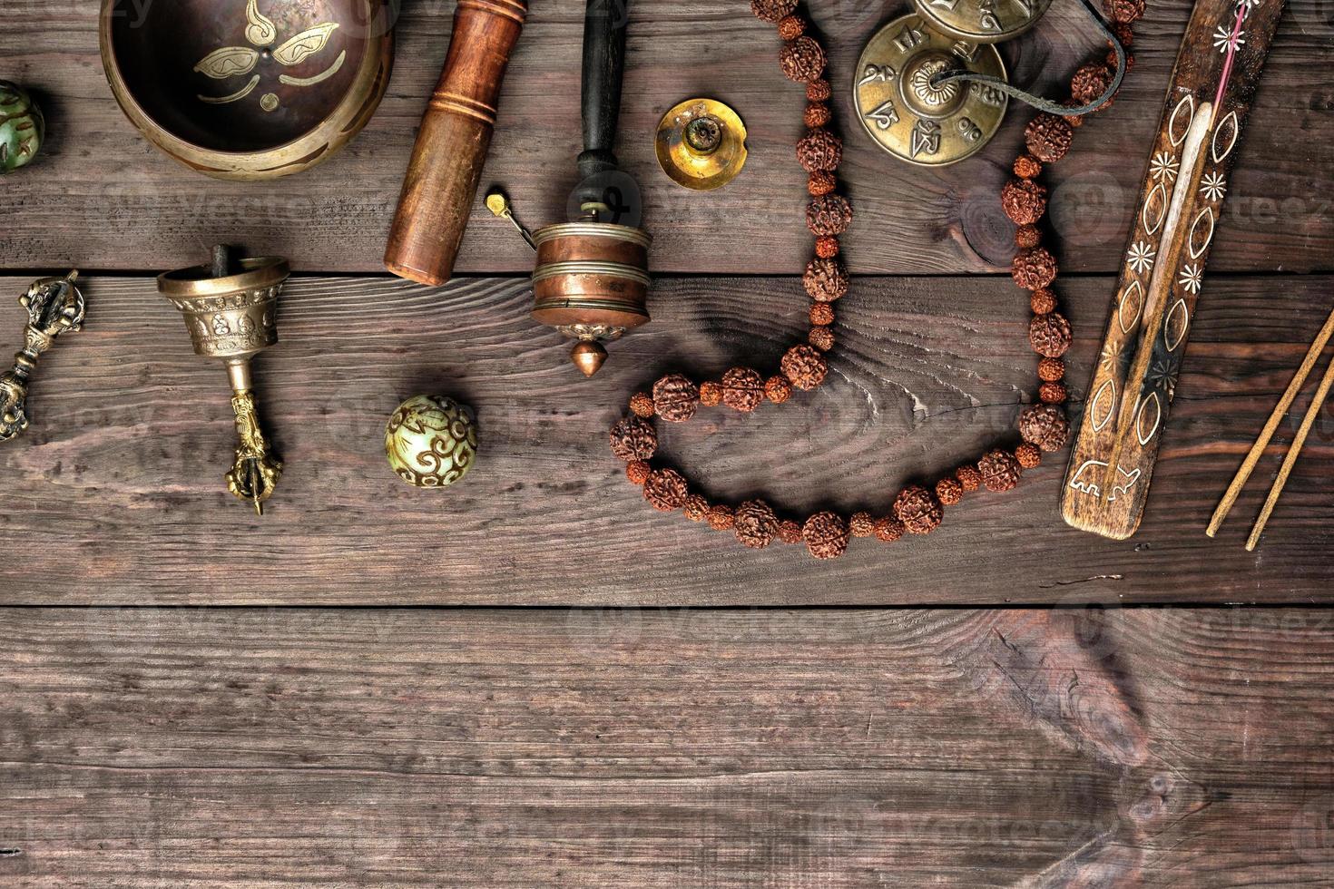 Copper singing bowl, prayer beads, prayer drum and other Tibetan religious objects photo