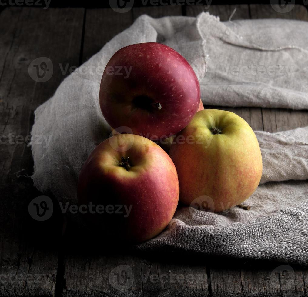 fresh red apples lies on a gray linen napkin photo