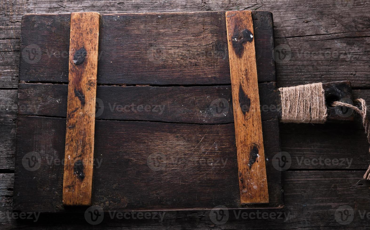very old brown square cutting board with a handle photo