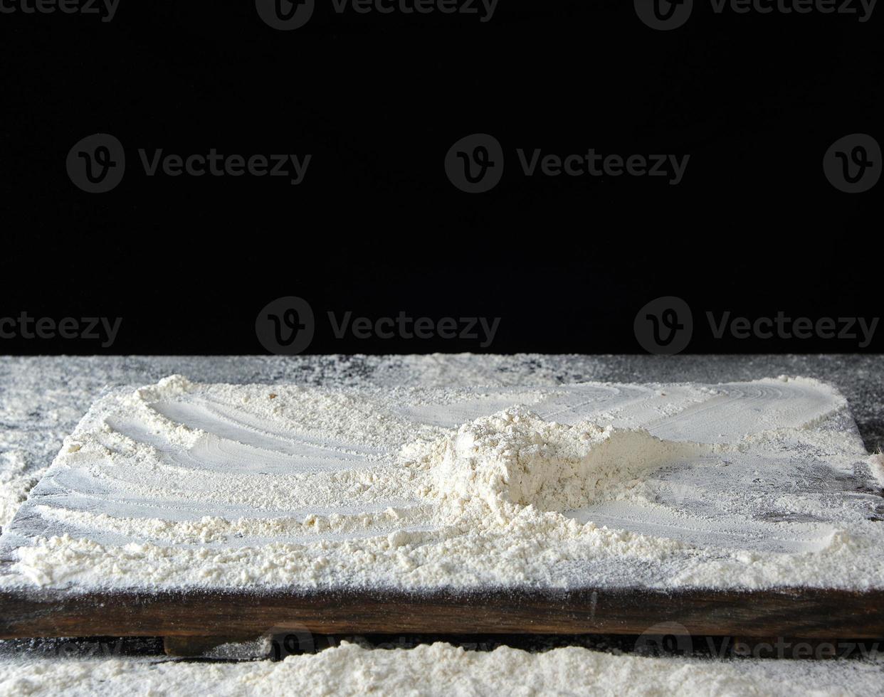 white wheat flour on a wooden brown board photo