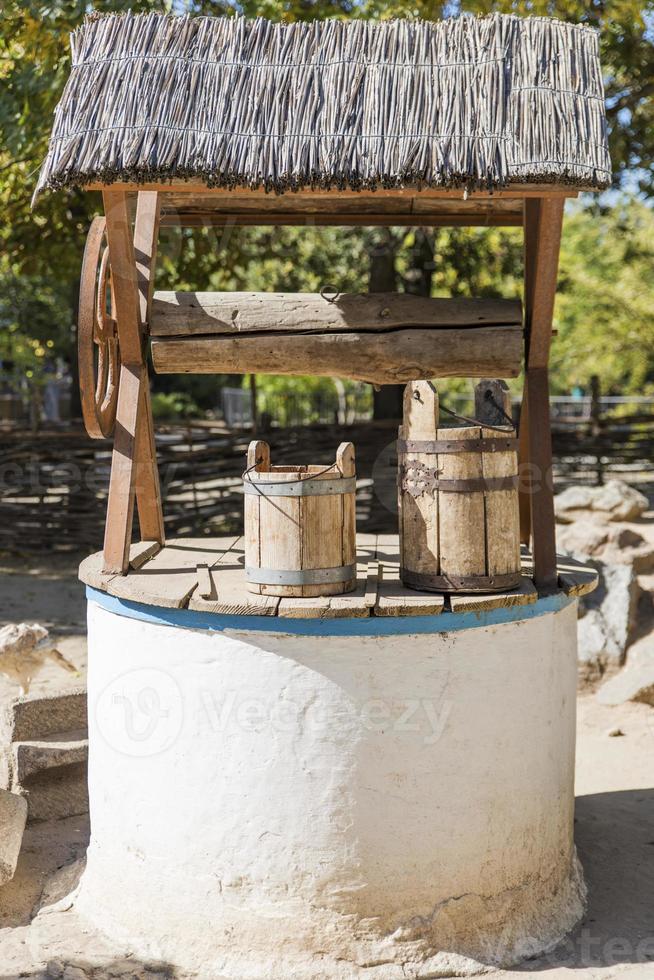 ancient well with drinking water photo