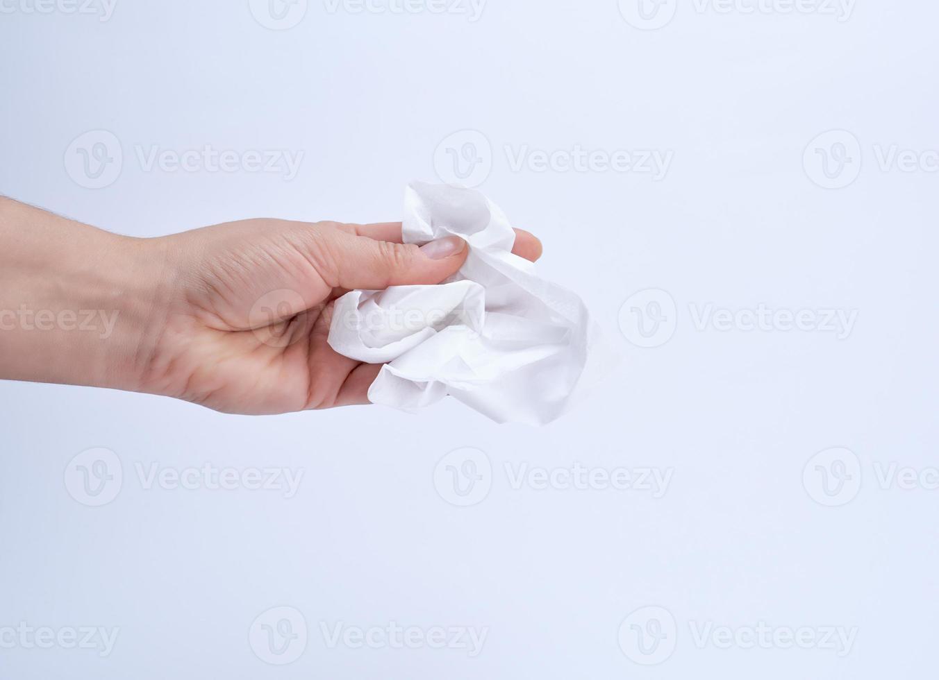 female hand holding a clean white paper napkin for face and body photo