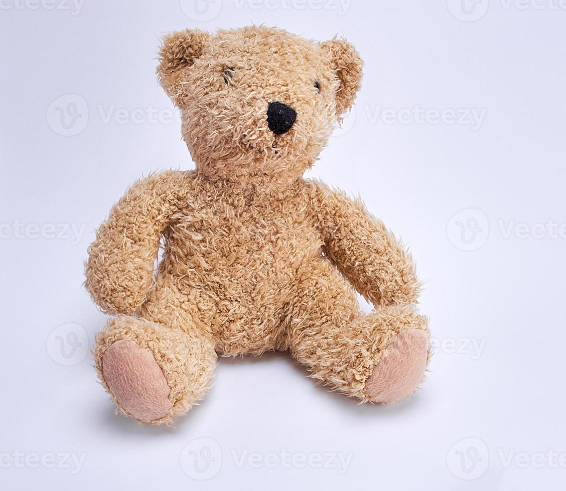 old brown teddy bear on a white background photo