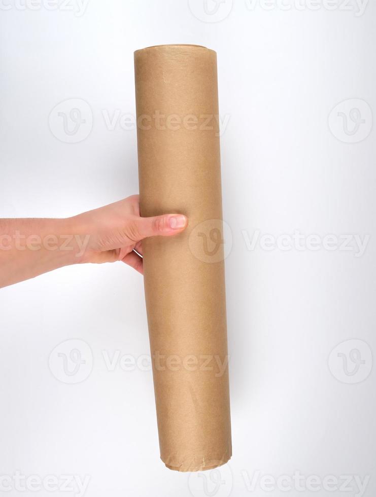 hand hold a large roll of brown parchment paper photo