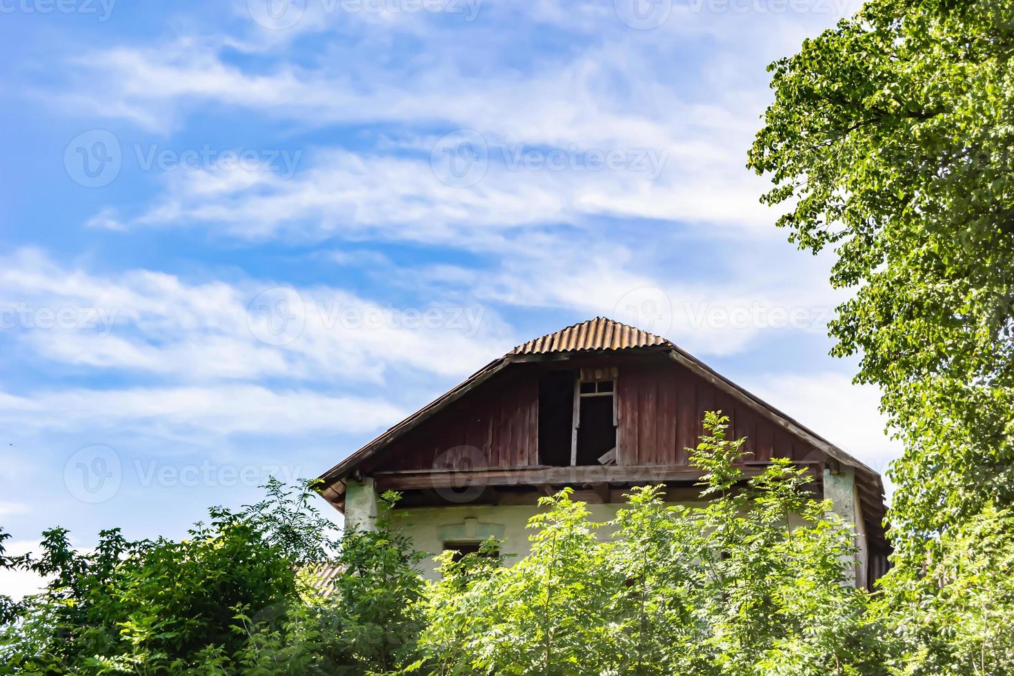 Beautiful old abandoned building farm house in countryside on natural background photo