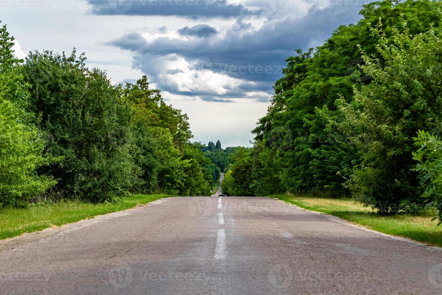 Beautiful empty asphalt road in countryside on colored background photo