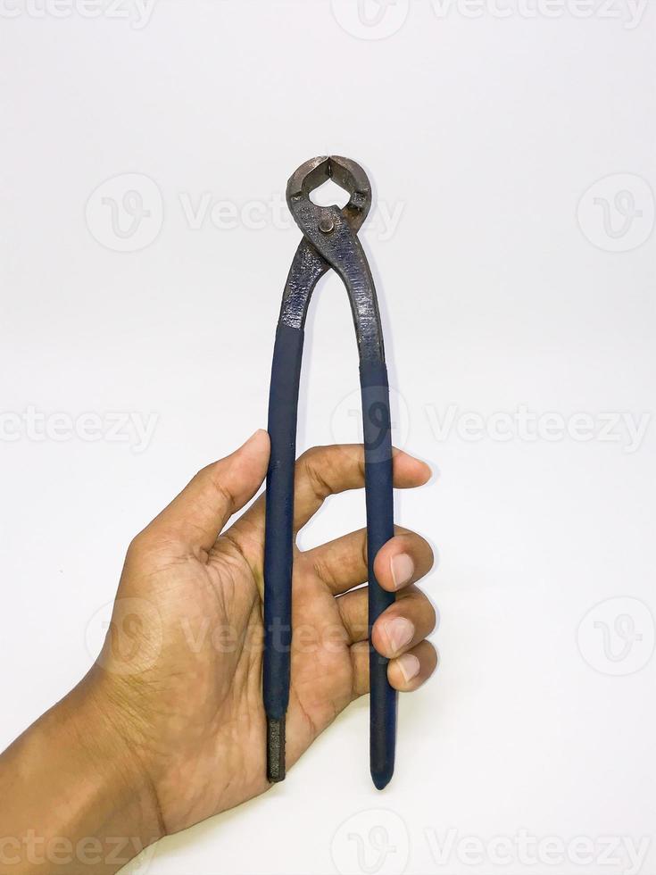 Holding nail puller pliers tang gegep kakaktua  isolated with a white background photo