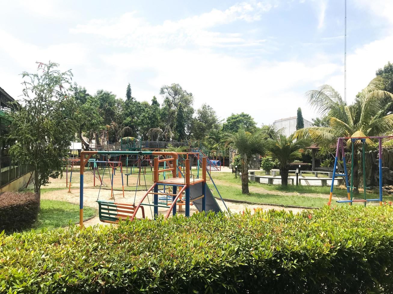 The play park for children is wrapped in red barrier tape. Outside. photo