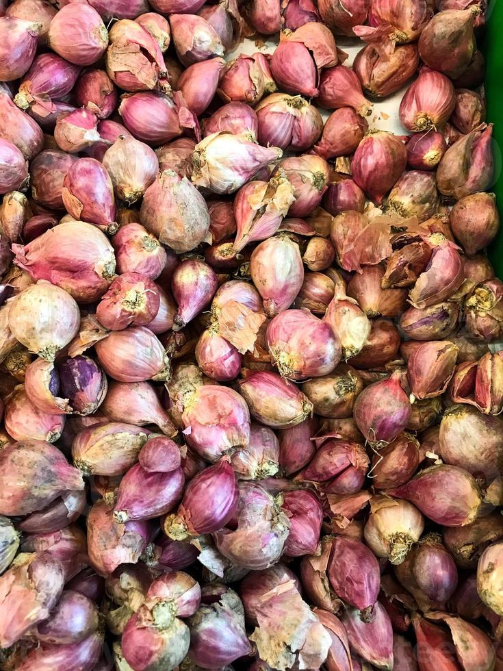 closeup pile of red onions, ingredient for cooking asian food photo