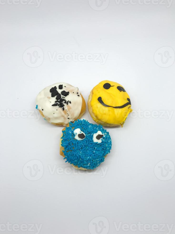 round donuts covered with jam with emoticon images photo