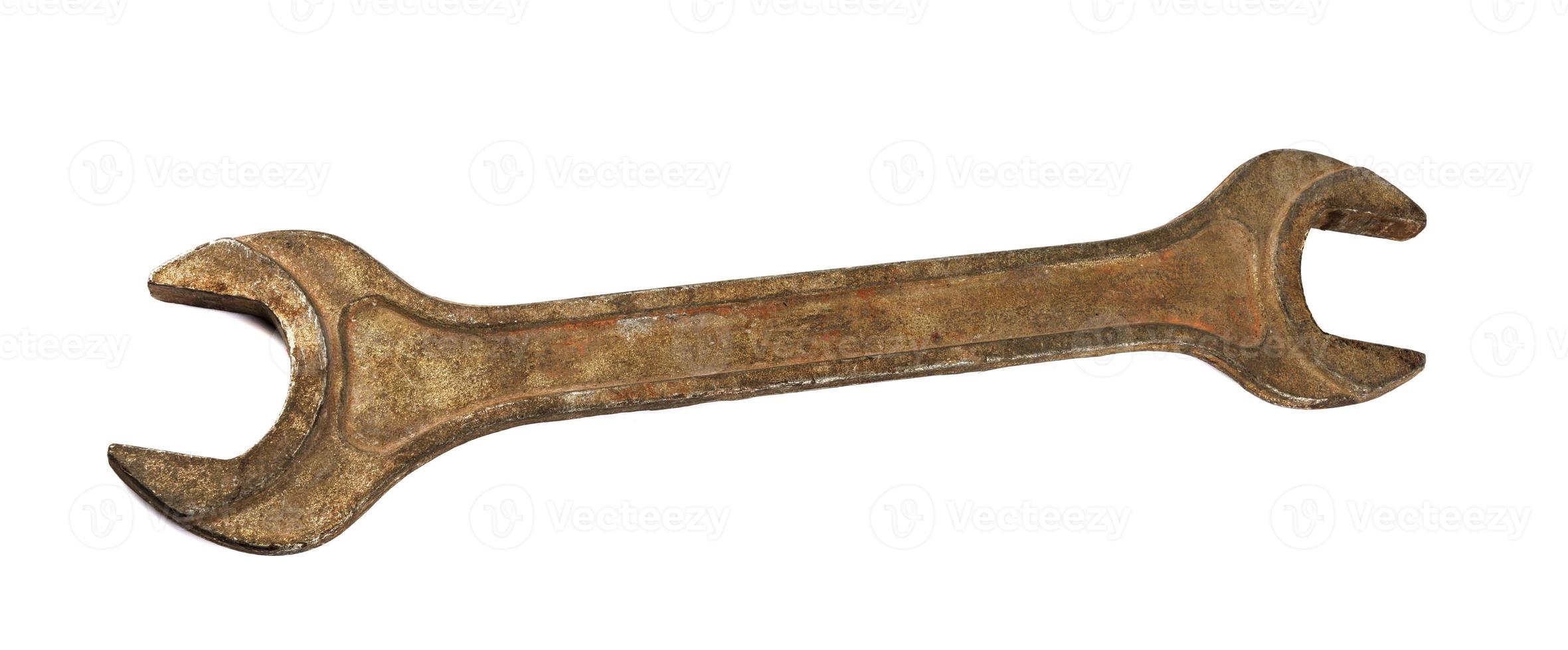 the old spanner is insulated against a white background. rusty wrench . photo