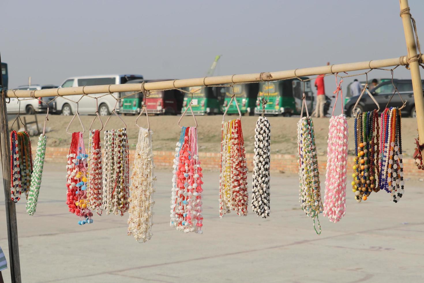 jewelry items made of sea snails displayed in seaside shops. photo