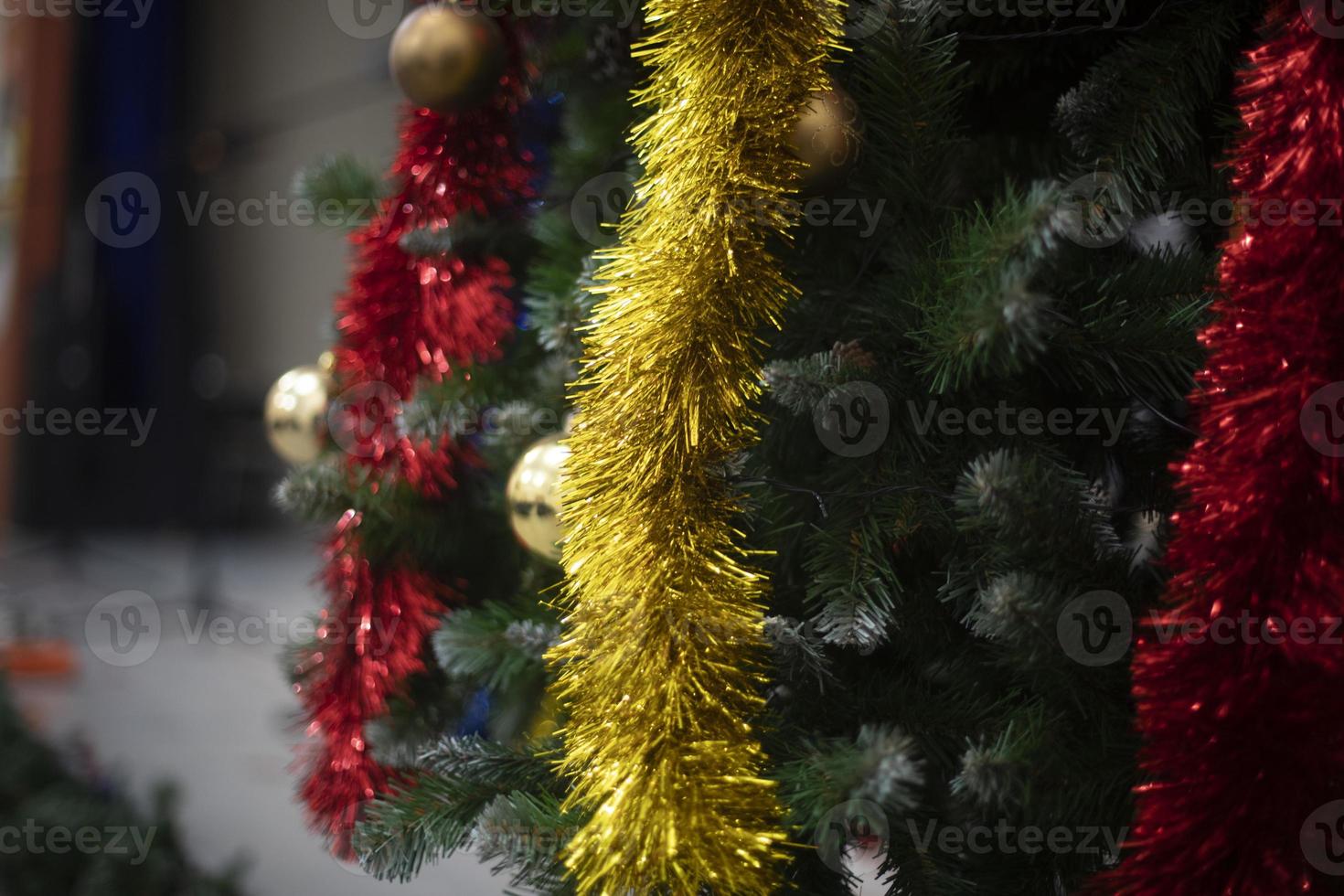 Toys and garlands for Christmas. Decorations on Christmas tree. Garlands on tree. photo