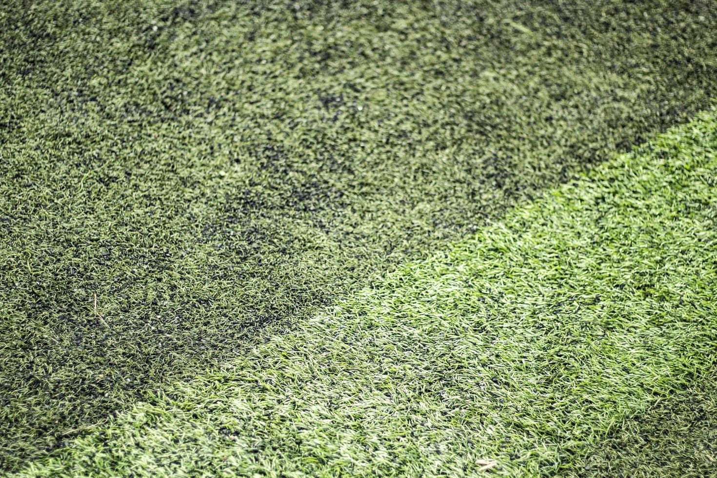 Football field coverage. Green background of artificial grass. Stadium details. photo