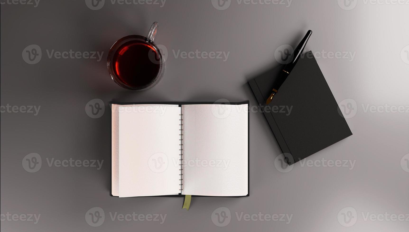 Top view of black notebook with pen and cup of tea on dark background photo