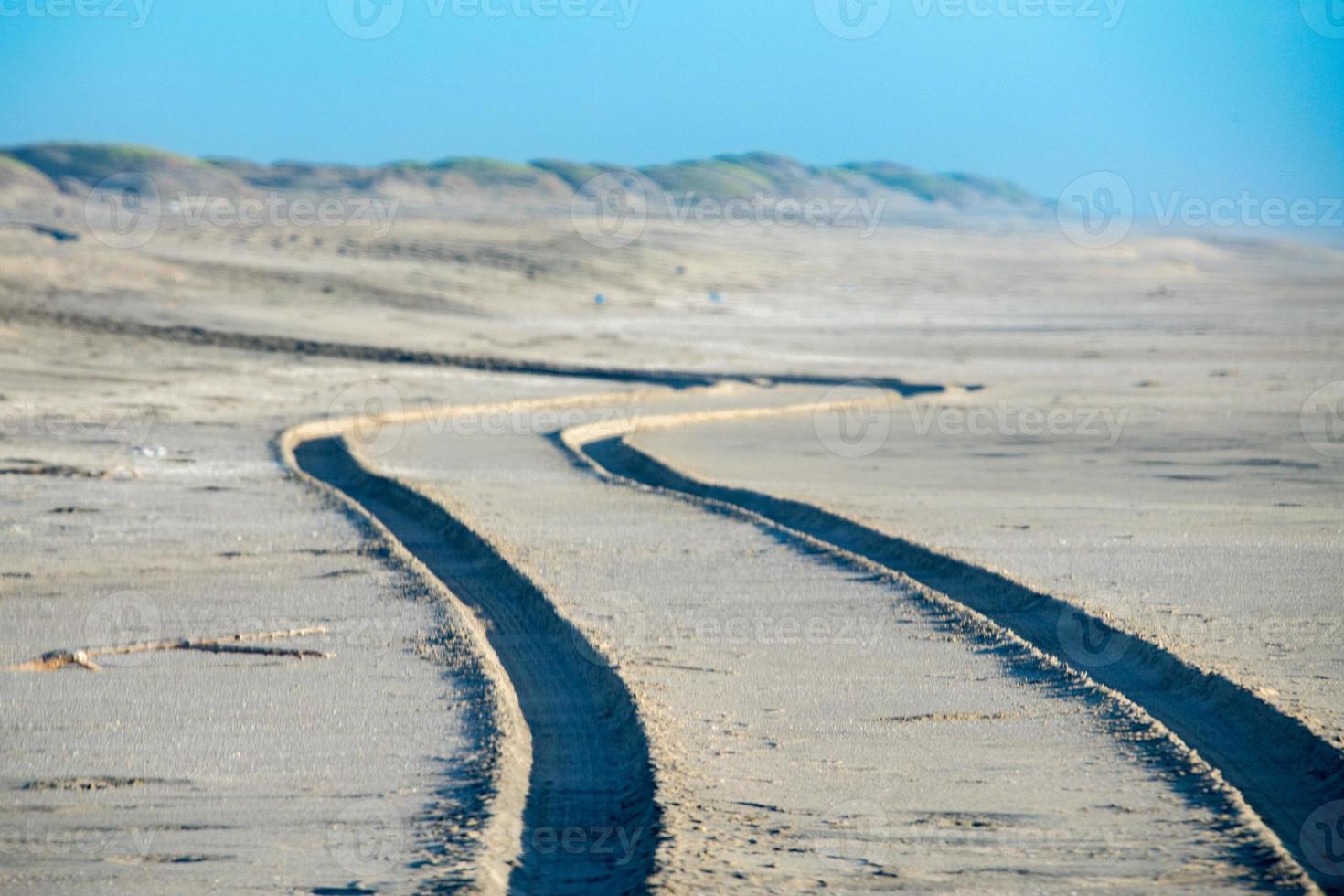offroad car tire  track detail on sand beach photo