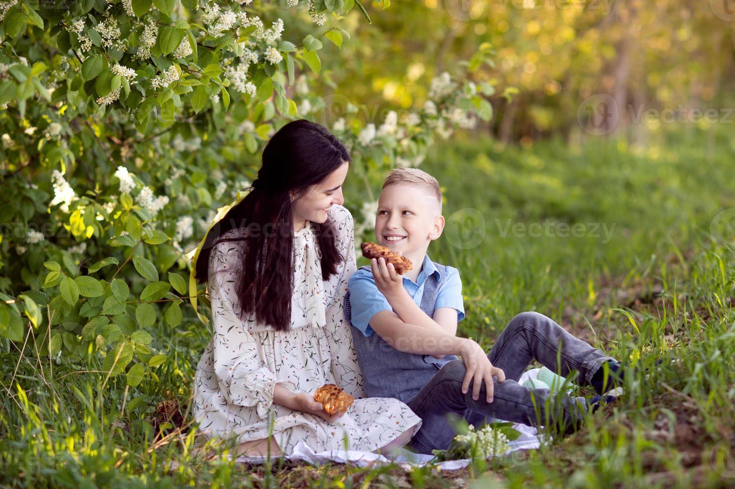 Cute baby treats mom to picnic food photo