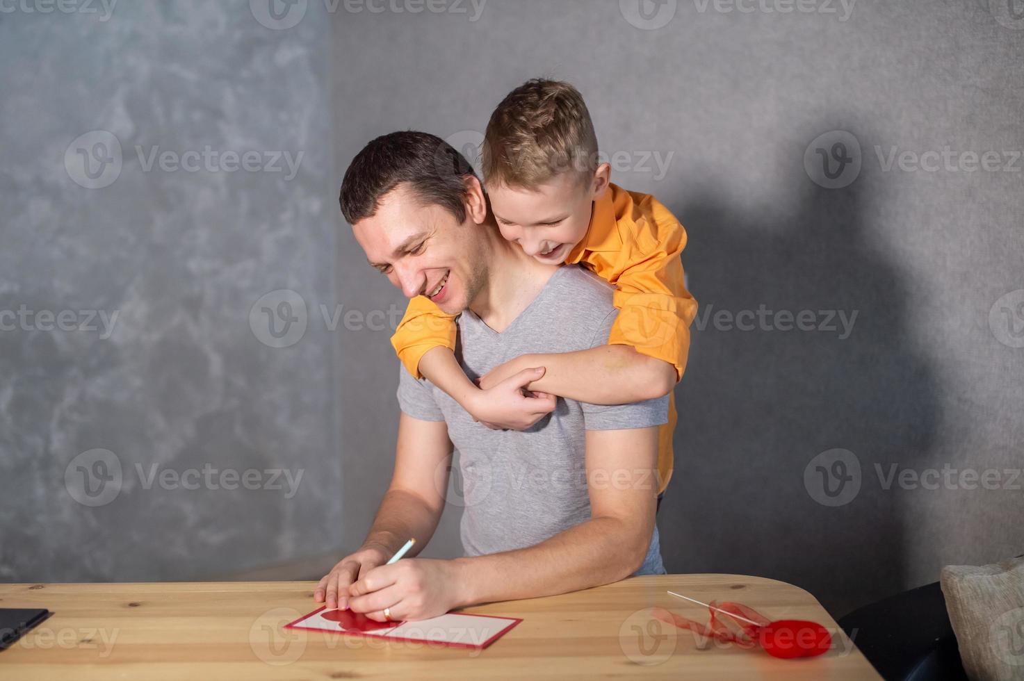 A happy boy hugs his dad . Preparations for Valentine's Day photo